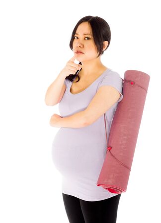 Pregnant adult asian woman isolated on white backgroundの写真素材