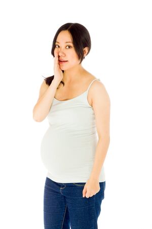 Pregnant adult asian woman isolated on white backgroundの写真素材