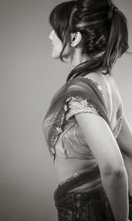 Adult indian woman in studio isolated on grey background, black and white imageの写真素材
