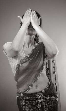 Adult indian woman in studio isolated on grey background, black and white imageの写真素材