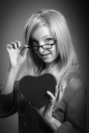Attractive caucasian blond girl isolated on a grey background, black and white imageの写真素材