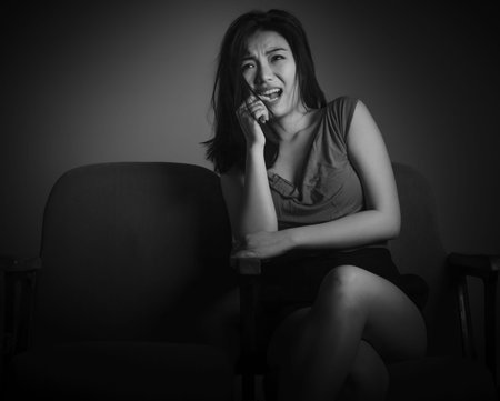Attractive Asian girl in her 20s at the theatre isolate on a white background, black and white image