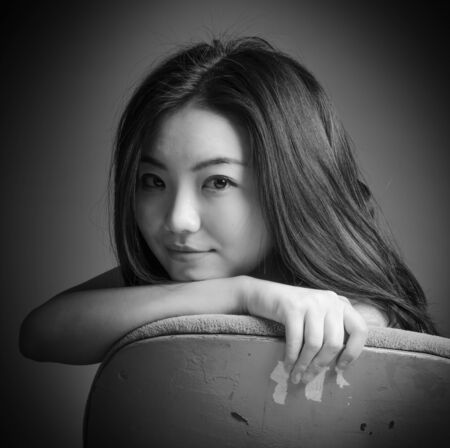 Attractive Asian girl in her 20s at the theatre isolate on a white background, black and white imageの写真素材