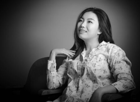 Attractive Asian girl in her 20s at the theatre isolate on a white background, black and white imageの写真素材