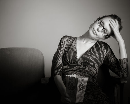 Attractive caucasian woman in the theatre in her 30 isolated on a grey background, black and white imageの写真素材
