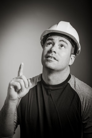 Caucasian contractor male 40 years old shot in studio isolated on grey background, black and white...