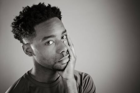Attractive afro-american man posing in a  studio isolated on a background, black and white imageの写真素材