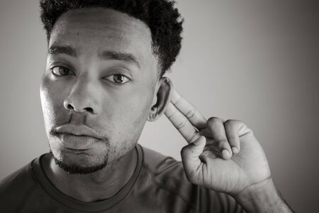 Attractive afro-american man posing in a  studio isolated on a background, black and white imageの写真素材