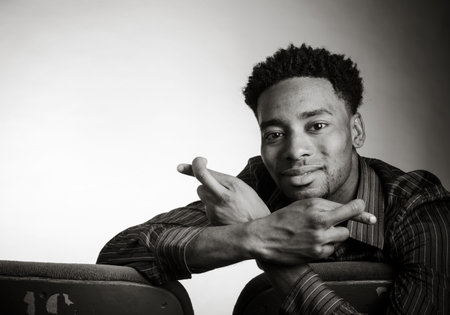 Attractive afro-american man posing in a  studio isolated on a background, black and white image