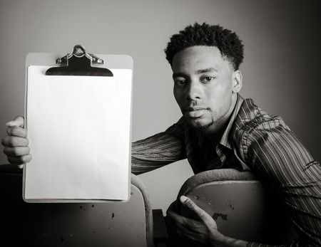 Attractive afro-american man posing in a  studio isolated on a background, black and white imageの写真素材