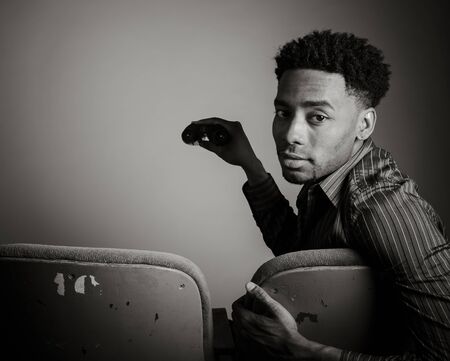 Attractive afro-american man posing in a  studio isolated on a background, black and white imageの写真素材
