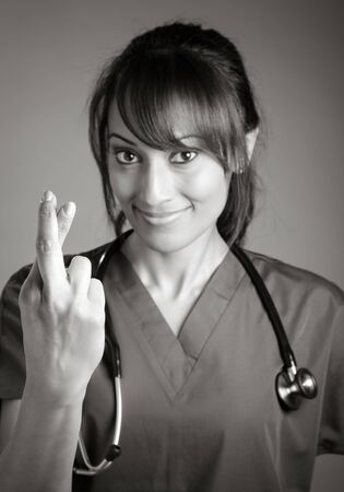 Attractive Indian doctor woman posing in a studio in front of a background, black and white imageの写真素材