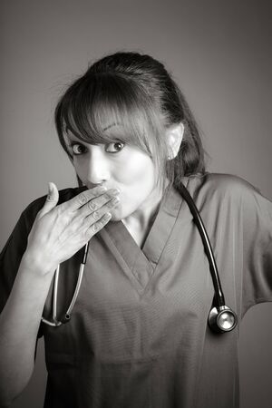 Attractive Indian doctor woman posing in a studio in front of a background, black and white imageの写真素材