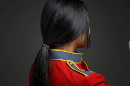 Model isolated on plain background in studio from rear pointingの写真素材