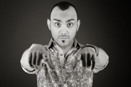 model isolated on plain background fingers pointing to camera