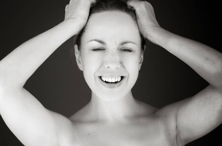 Model in studio isolated on plain grey backgroundの写真素材