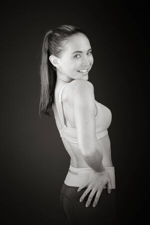 Model in studio isolated on plain grey backgroundの写真素材