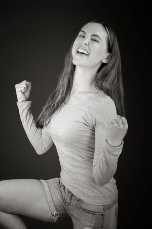 Model in studio isolated on plain grey backgroundの写真素材