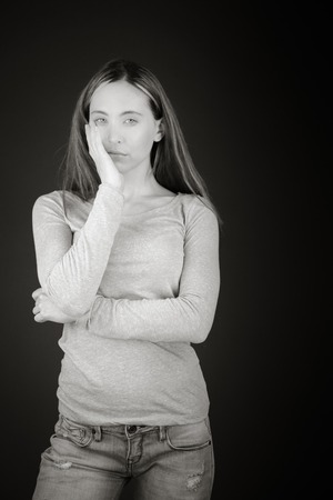 Model in studio isolated on plain grey backgroundの写真素材