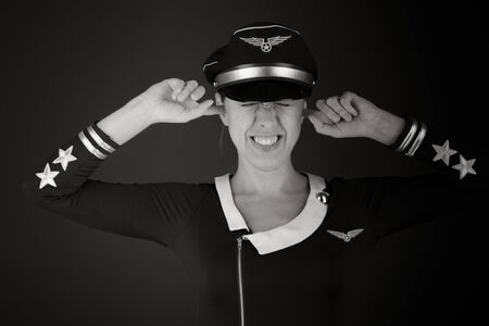 Model isolated on plain plugging ears with fingersの写真素材