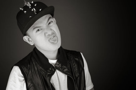 Model isolated on plain face sticking tongue out
