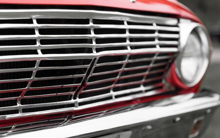 Close-up of radiator grille of a red classic vintage carの写真素材