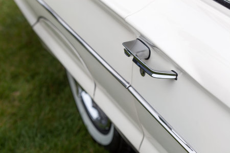 Close-up of car handle of a white classic vintage car