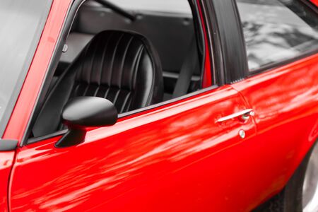 Black seat of a red shiny classic vintage carの写真素材
