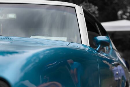 Wing mirror of a blue shiny classic vintage carの写真素材