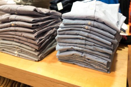 Stack of shirts in clothes shopの写真素材