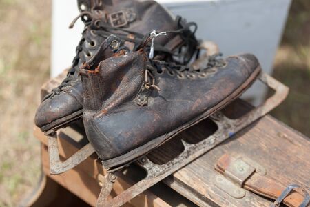 Close-up of old ski boot on wooden box for sale at flea marketの写真素材