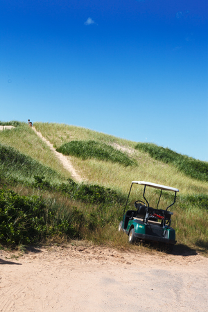 Golf cart parked on golf course, Prince Edward Island, Canadaの写真素材