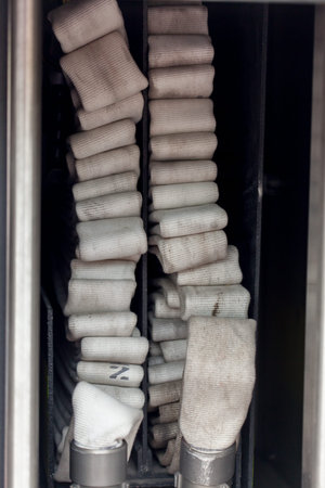 Close-up of rolled up hose in fire vehicleの写真素材