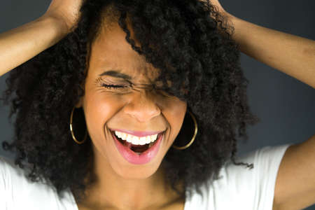 attractive woman on plein background shot in studio with soft lights with an interesting expression and dramatic lightingの写真素材