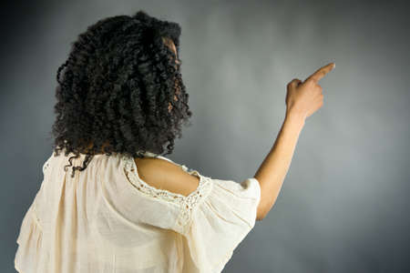 attractive woman on plein background shot in studio with soft lights with an interesting expression and dramatic lightingの写真素材