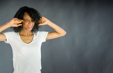 attractive woman on plein background shot in studio with soft lights with an interesting expression and dramatic lightingの写真素材
