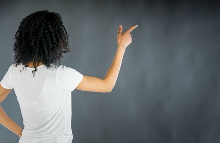 attractive woman on plein background shot in studio with soft lights with an interesting expression and dramatic lightingの写真素材