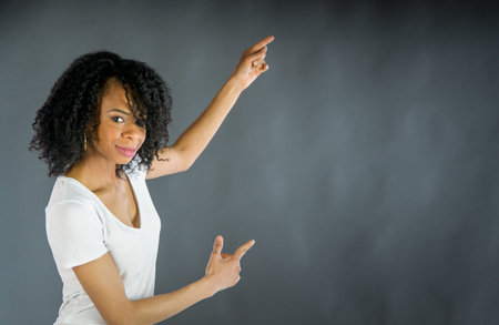 attractive woman on plein background shot in studio with soft lights with an interesting expression and dramatic lightingの写真素材
