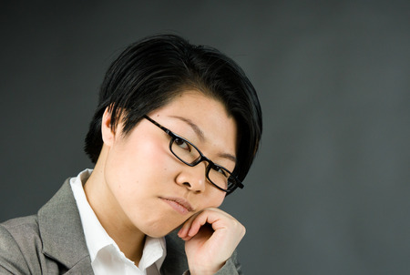 attractive woman on plein background shot in studio with soft lights with an interesting expression and dramatic lightingの写真素材