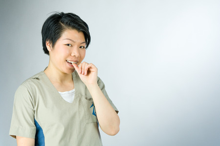 attractive woman on plein background shot in studio with soft lights with an interesting expression and dramatic lightingの写真素材
