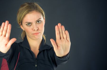 attractive woman on plein background shot in studio with soft lights with an interesting expression and dramatic lightingの写真素材