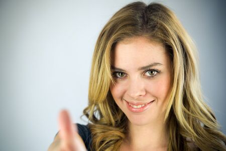 attractive woman on plein background shot in studio with soft lights with an interesting expression and dramatic lightingの写真素材