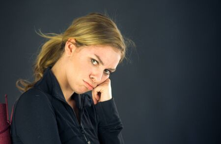 attractive woman on plein background shot in studio with soft lights with an interesting expression and dramatic lightingの写真素材