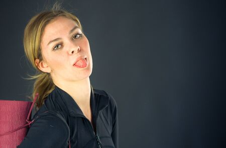 attractive woman on plein background shot in studio with soft lights with an interesting expression and dramatic lightingの写真素材
