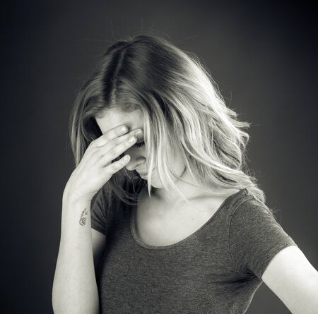 attractive woman on plein background shot in studio with soft lights with an interesting expression and dramatic lighting Black And White, b&wの写真素材