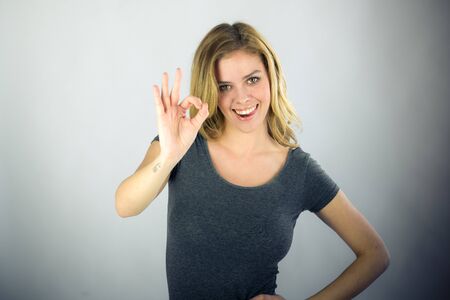 attractive woman on plein background shot in studio with soft lights with an interesting expression and dramatic lightingの写真素材