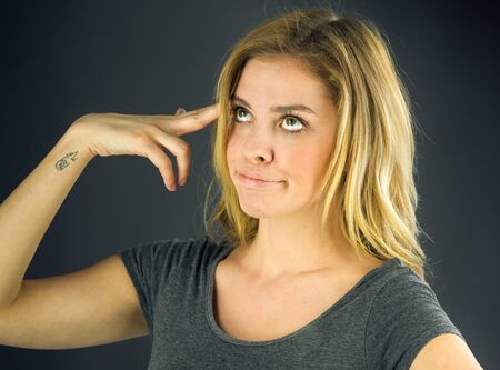 attractive woman on plein background shot in studio with soft lights with an interesting expression and dramatic lightingの写真素材