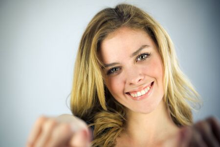 attractive woman on plein background shot in studio with soft lights with an interesting expression and dramatic lightingの写真素材