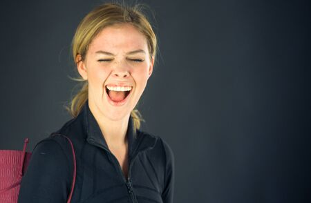 attractive woman on plein background shot in studio with soft lights with an interesting expression and dramatic lightingの写真素材