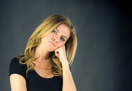 attractive woman on plein background shot in studio with soft lights with an interesting expression and dramatic lightingの写真素材